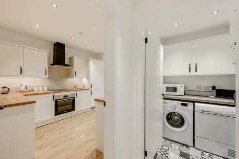 Kitchen and utility area with patterned floor