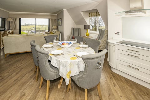 Open-plan kitchen and dining space with views over the course