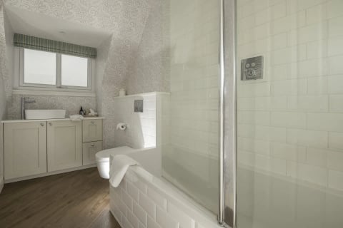 Family bathroom with bath and white suite