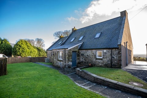 The cottage gable with pale blue door
