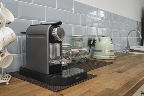 Nespresso machine and pastel kettle on the worktop