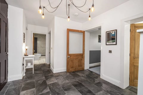 Hall with filament pendant and slate floor