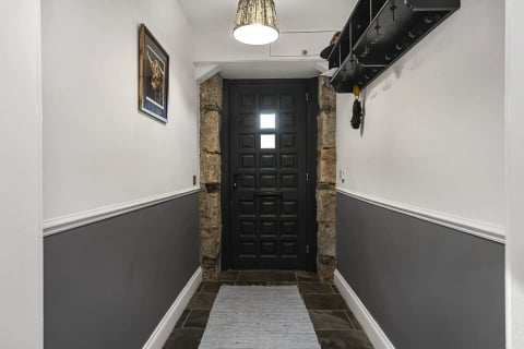 The black studded jail door in the grey hall