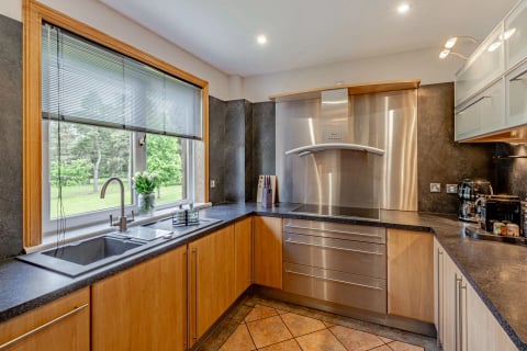 Kitchen with stainless hob, extractor and granite worktops
