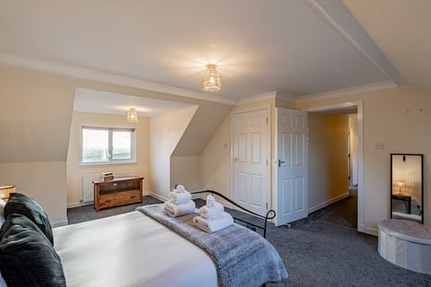 Double bedroom with black iron bed and dresser