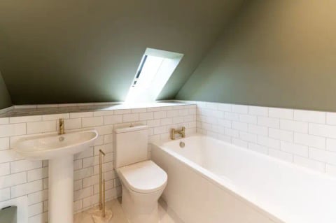 Bath beneath the skylight with metro tiles