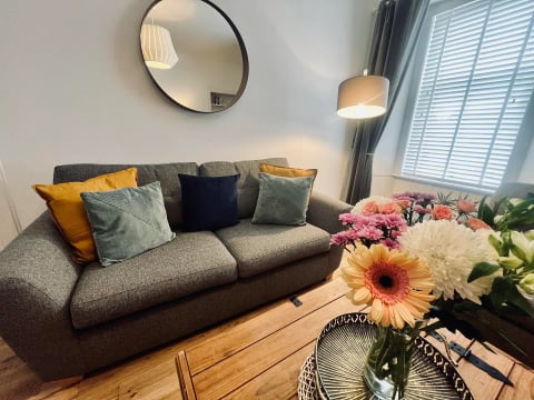 Living room with fresh flowers and comfortable seating