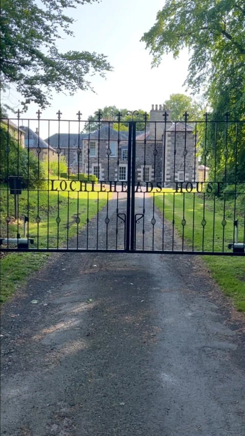The estate gates with the house beyond