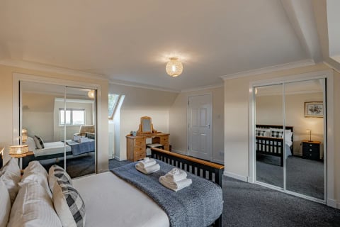 King bedroom with mirrored wardrobes and dressing table