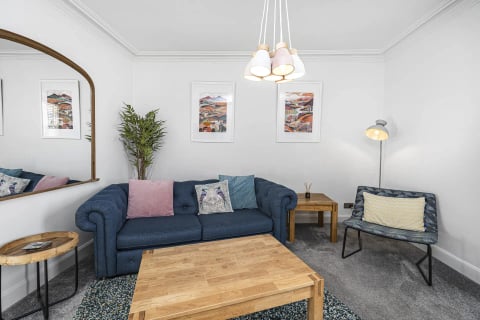 Living room with navy Chesterfield and Scottish prints
