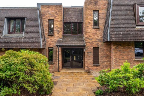 The apartment block entrance with paved path