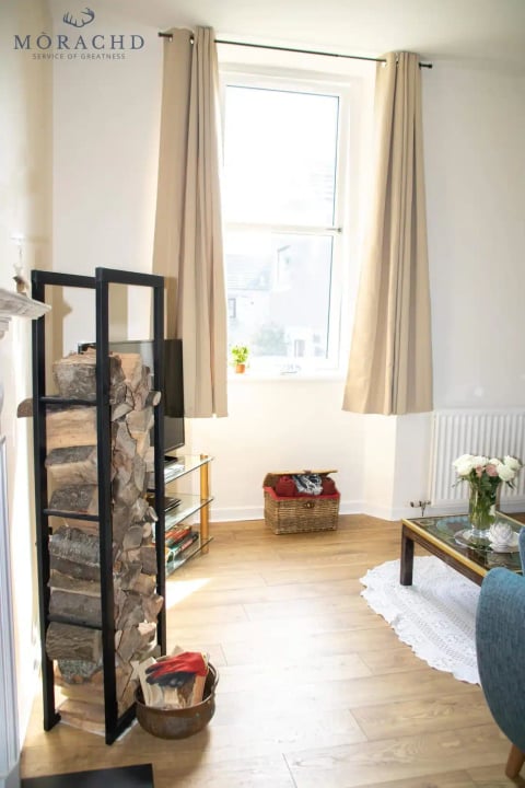 Lounge corner with log store and window light