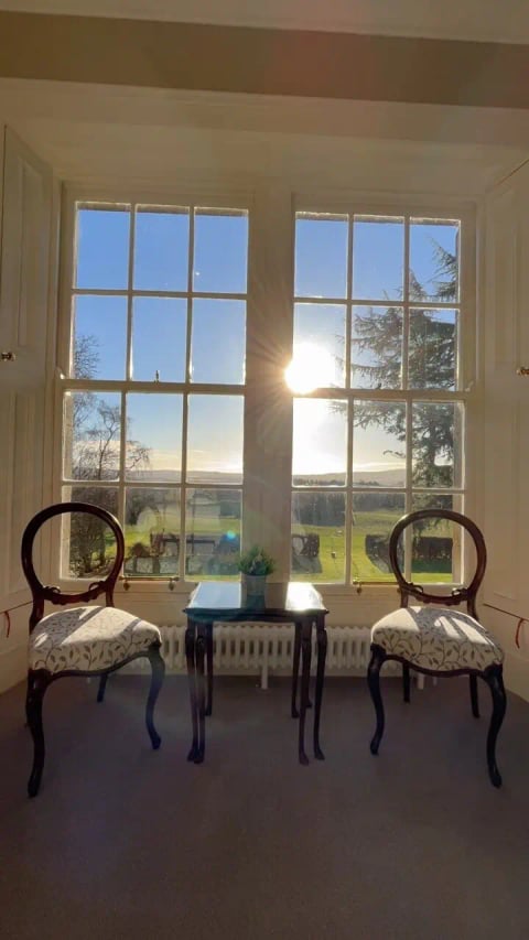 Antique chairs in the sunlit bay window