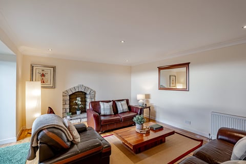 Living room with leather sofas and stone fireplace