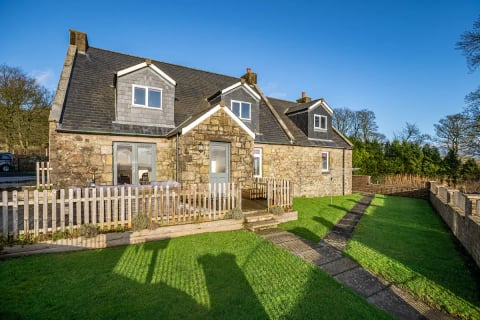 Little Ballo Cottage - stone farmhouse with picket-fenced lawn