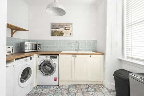 Duck-egg splashback with washer and vintage prints