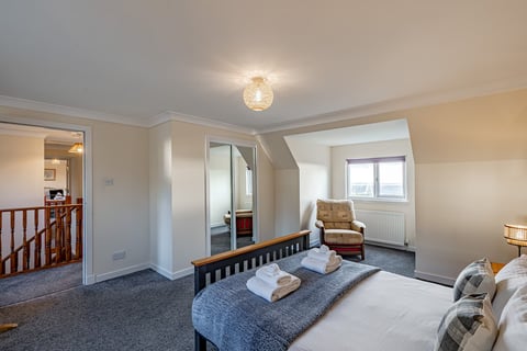 Bedroom with dormer window and armchair