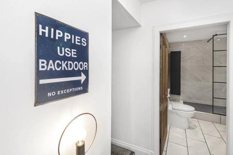 'Hippies use backdoor' sign by the bathroom