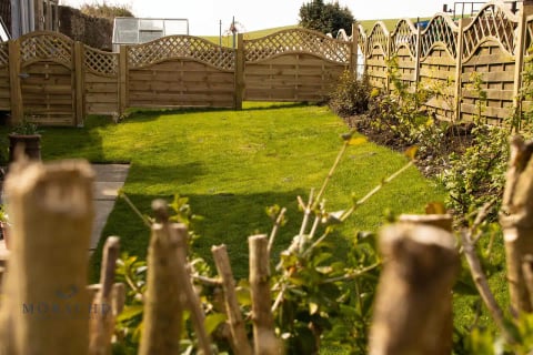 Enclosed lawned garden with timber fencing
