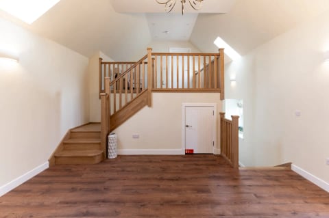 Oak staircase rising from the entrance hall