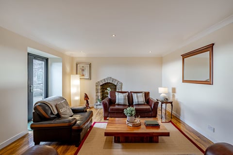 Lounge with stone hearth and wooden coffee table