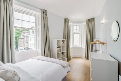 Bedroom with bay windows and shelf unit
