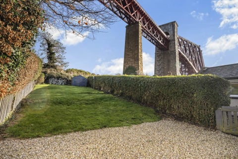 The rail bridge towering over the garden