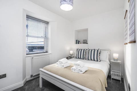 Double bed with striped cushions in the alcove room