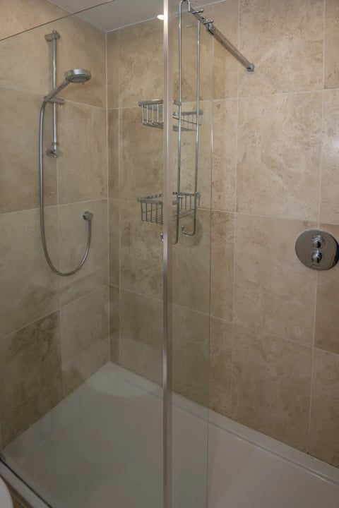 Stone-tiled shower with twin baskets