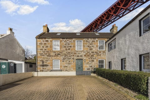 The Old Jail's brick-paved drive and green door