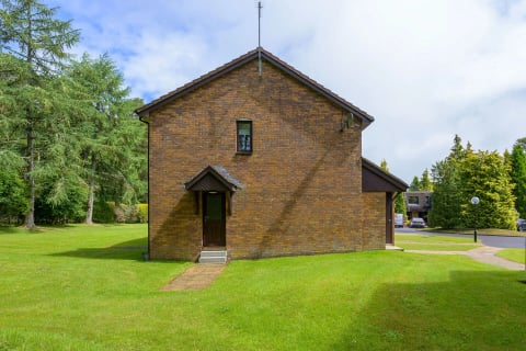 The gable end of the brick cottage on the green