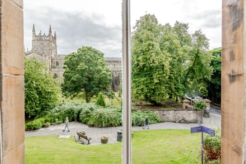 The abbey green through the trees