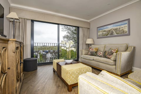 Bright living room with balcony doors overlooking the golf course