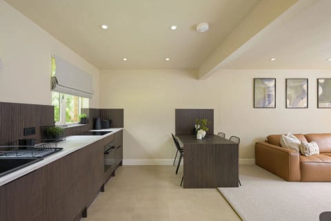 Kitchen and dining space with dark units