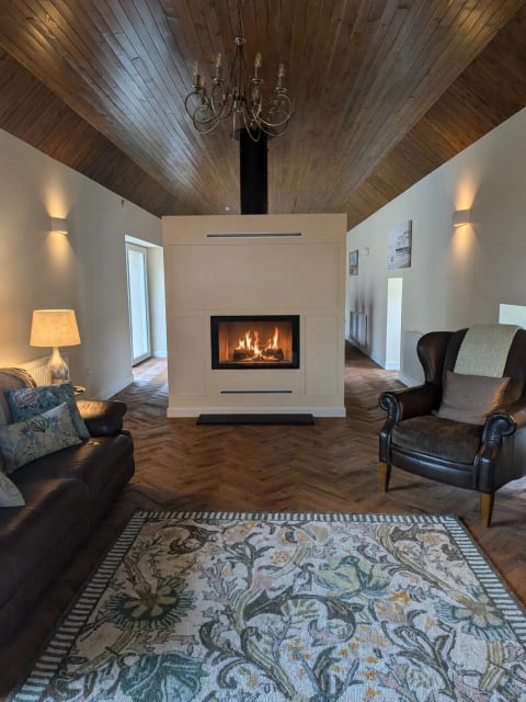 The lounge fireplace flanked by leather armchairs