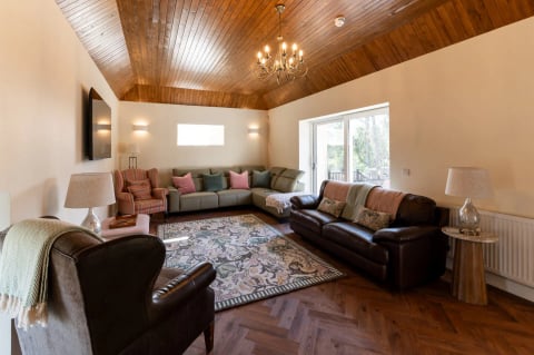 The sitting room under the vaulted wooden ceiling