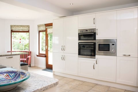 Cream gloss kitchen with built-in double oven