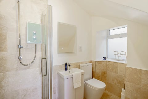 Shower room with walk-in enclosure and white suite