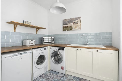 Utility with twin washers and coastal artwork