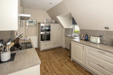 Cream kitchen under the eaves with skylight