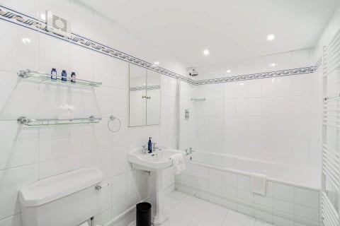 White-tiled family bathroom