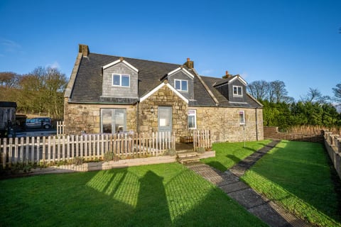 Rear elevation with picket fence and lawns