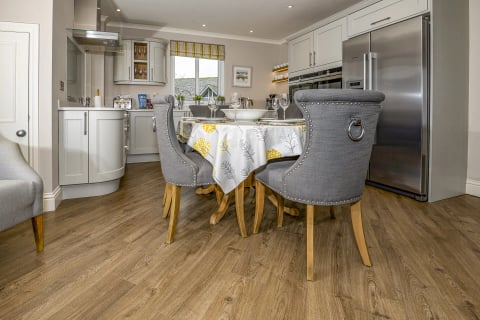 Kitchen and dining area with upholstered grey chairs