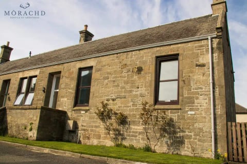 The stone rear elevation of the cottage