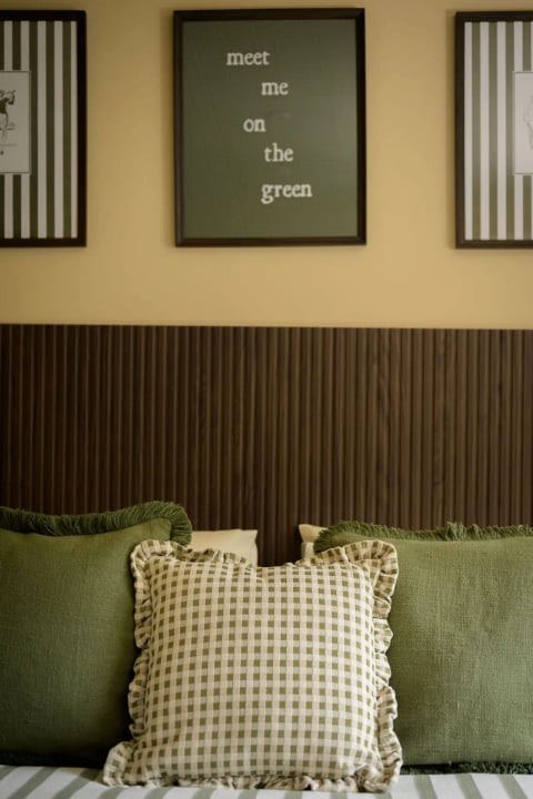 Bed with gingham cushions and 'the green' print