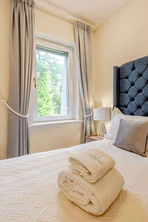 Single bedroom with buttoned navy headboard