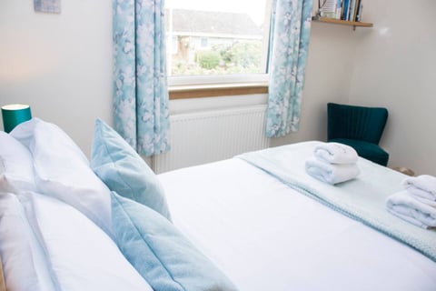 Twin bedroom with duck-egg curtains