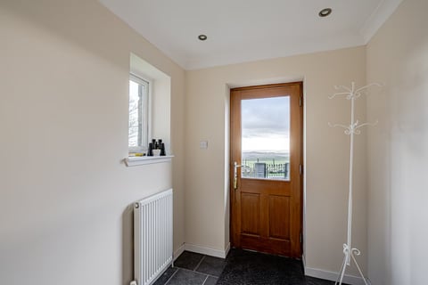 Entrance hall with timber door and binoculars on the sill
