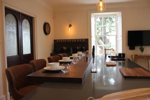 Long breakfast bar with copper tap and pendant lights