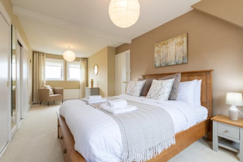 Master bedroom with king bed and soft neutral throws